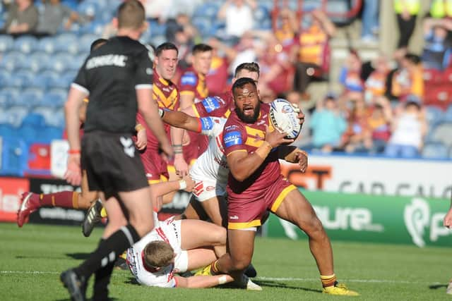 Huddersfield's Ukuma Ta'ai takes on the Saints defence (PIC: TONY JOHNSON)