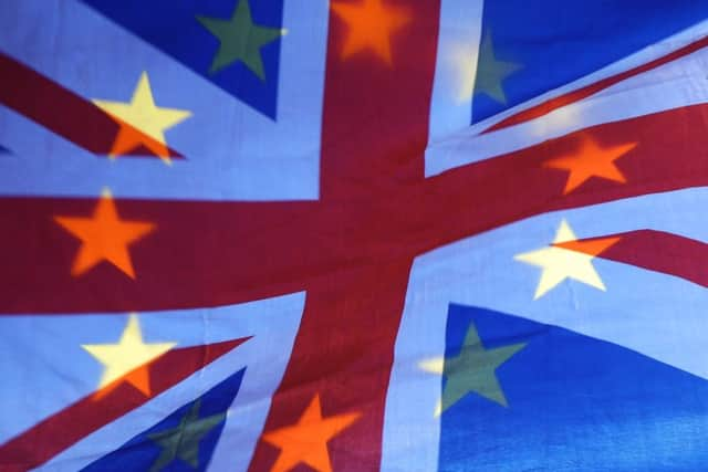 File photo dated 23/04/19 of an EU and Union flag held aloft in Westminster, London. Photo credit should read: Yui Mok/PA Wire