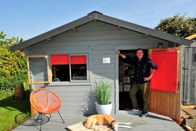 Andy outside 'The Garden Shed' with dog Toby.