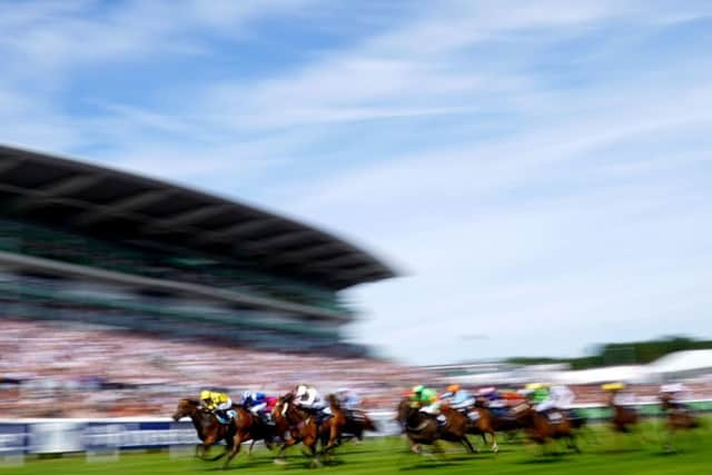 Phil Dennis and Orn ate (left) win the Dash at Epsom on derby day, just missing out on a world record time.