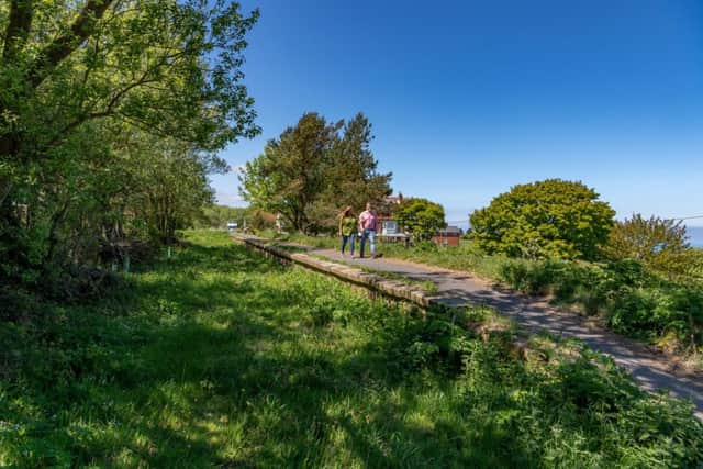 Date: 21st May 2019.
Picture James Hardisty.
YP Magazine.......Ravenscar, near between Whitby and Scarborough on the East Yorkshire Coast made famous by Victorian developers who planned a new Yorkshire resort with its very own coastal train line, large hotel and a number of built plots for sale. In the end the resort was never completed - hence the tag 'The Town That Never Was' - and the railway line finally closed in the 1960s. A couple from Malton, North Yorkshire Amanda Batcheler and Marcus Aldrich, have spent the last three years researching the history and wrote a book about Going Once..Going Twice..Going Wrong..about this forgotten seaside town. Pictured The former platform for Ravenscar station.