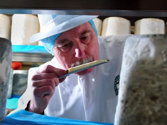 An employee at Wensleydale Creamery in Hawes