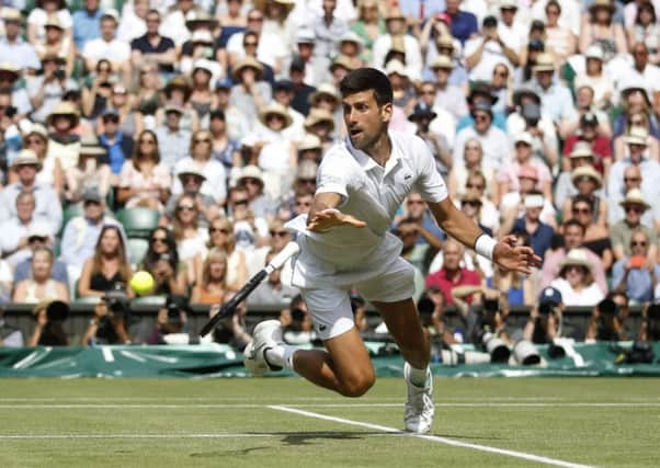 Novak Djokovic dives to his left in his match against Roberto Bautista Agut. Picture: Carl Recine/PA