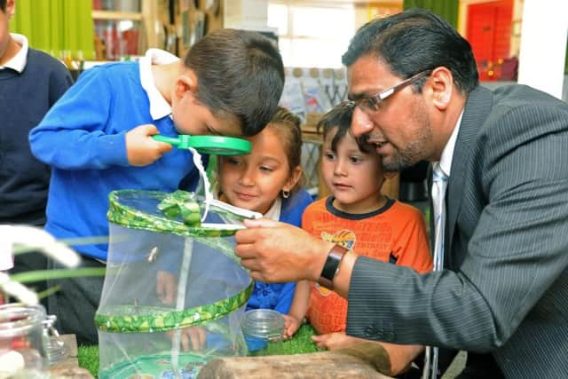 Feversham Primary Academy headteacher, Naveed Idrees working with children in nursery.