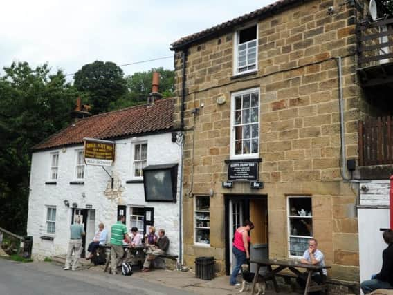 Tourists gather outside the Birch Hall Inn