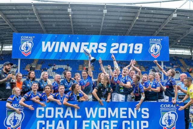 Champions: Leeds captain Courtney Hill lifts the trophy after victory over Castleford.