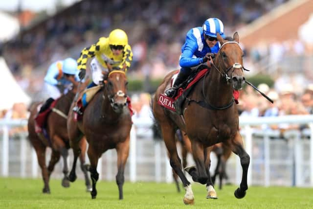 Battaash ridden by Jim Crowley (white and blue silks) on his way to win the King George Qatar Stakes for a third time in succession at Goodwood.