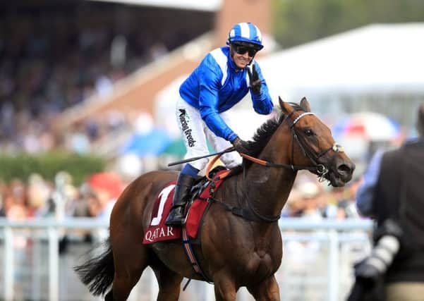 Battaash's jockey Jim Crowley salutes the horse's third win int eh King George Qatar Stakes.