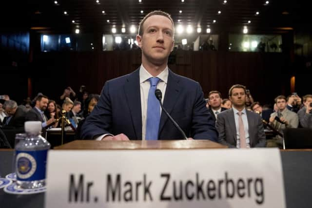 Facebook CEO Mark Zuckerberg arrives to testify before a joint hearing of the Commerce and Judiciary Committees on Capitol Hill in Washington, Tuesday, April 10, 2018, about the use of Facebook data to target American voters in the 2016 election. (AP Photo/Andrew Harnik)