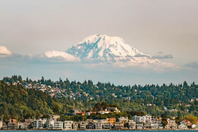 Mount Rainier emerging from the clouds above the city.