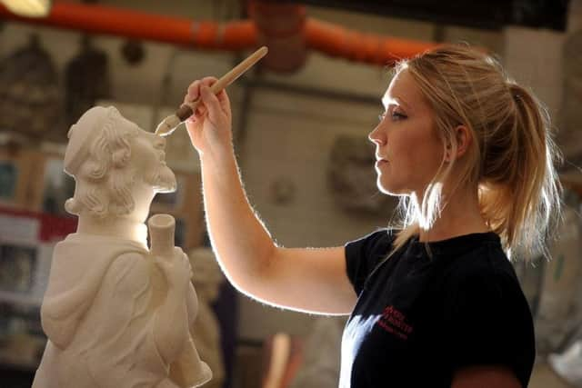 Stonemason Harriet Pace pictured with the grotesque she has completed, a Medieval Doctor based on her late father Martin Pocture: Simon Hulme