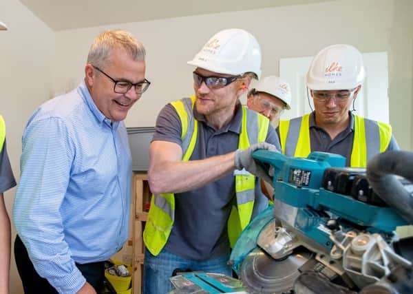 Dave Sheridan examines machinery at the academy.