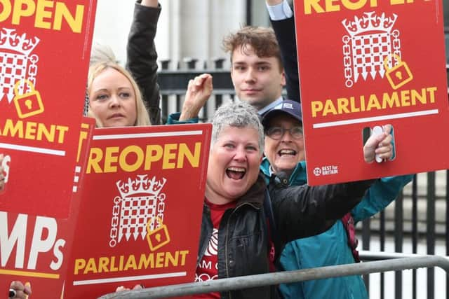 Protesters celebrate outside the Supreme Court after judges said it was unlawful to shut down Parliament.