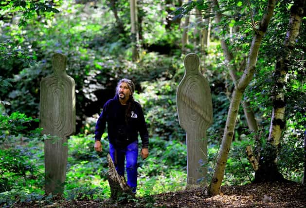 Andrew Vickers  of Stoneface Creative , with his  sculpture figures of his children Tom and Lydia.