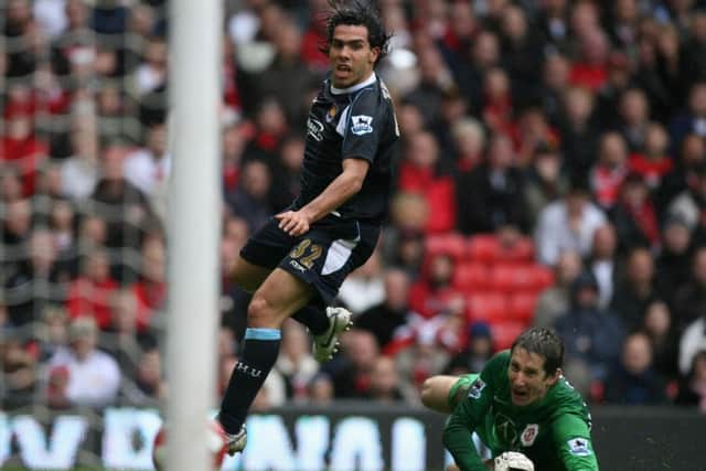 West Ham United's Carlos Tevez, left, scores past Manchester United's goalkeeper Edwin Van Der Sar on May 13, 2007. Picture: AP/Jon Super.