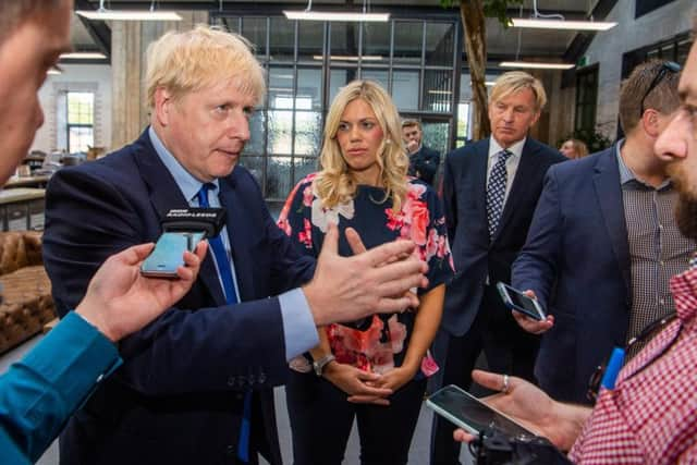 Prime Minister Boris Johnson at Fox Valley Shopping Centre, Stocksbridge, Sheffield. Pictured Prime Minister Boris Johnson, with Miriam Cates, Conservative parliamentary candidate for Penistone & Stocksbridge, South Yorkshire, and Mark Dransfield, Owner of Fox Valley Shopping Centre, and MD of Dransfield Properties.