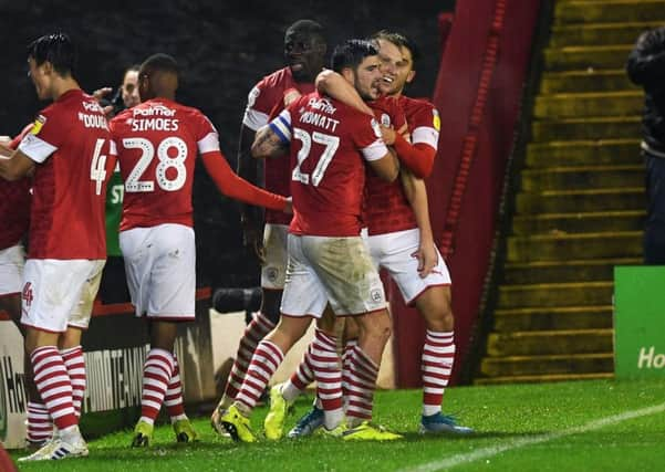 Barnsley's Cauley Woodrow celebrates with Alex Mowatt, after making it 2-2 late on. Picture Jonathan Gawthorpe