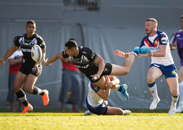 New Zealand's full-back Roger Tuivasa-Sheck offloads to Jamayne Isaako during the game against Great Britain at Eden Park. Picture: Brett Phibbs / www.photosport.nz /SWpix.com