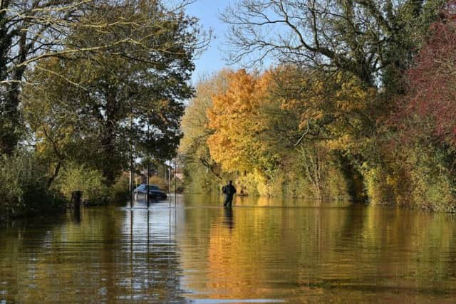 A man wades through floodwater in Fishlake, Doncaster. Ben Birchall/PA Wire