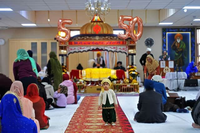 Worshipers at the Guru Nanak Gurdwara Sikh Temple, Huddersfield, celebrating the 550th anniversary of their founding guru.  Picture by Tony Johnson