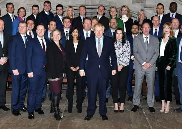 Boris Johnson alongside the new intake of Tory MPs.