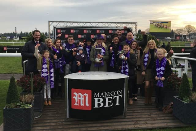 Connections of Lady Buttons celebrate a famous win.