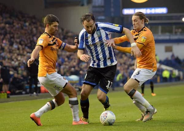 Owls' Atdhe Nuhiu goes between Hull City pair of Eric Lichaj and Jackson Irvine.