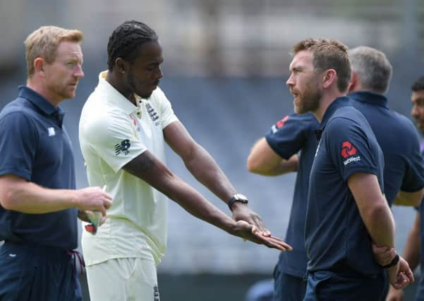 BAD SIGN: England bowler Jofra Archer chats with physio Craig de Weymarn at Newlands in Cape Town. Picture: Stu Forster/Getty Images