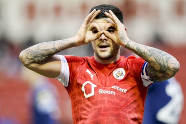 Eyes on survival: 
Barnsley captain Alex Mowatt celebrates after slotting home the opening goal at Oakwell