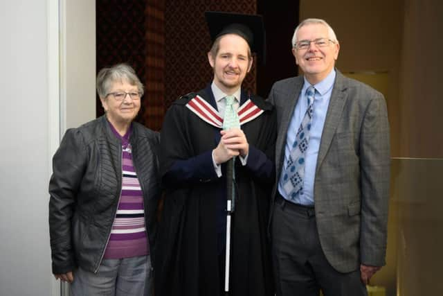 Giles pictures with his parents 25 years on from Swansea University