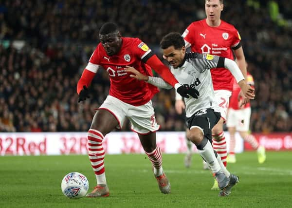 Barnsley's Bambo Diaby (left) battles with Derby County's Duane Holmes earlier this month at Pride Park. Picture: Bradley Collyer/PA