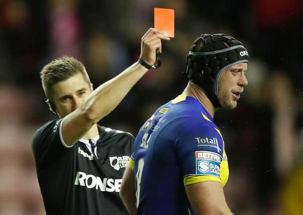 welcome back: Warrington Wolves Chris Hill is sent off by referee Chris Kendall after just 22 minutes for a tackle on Wigan Warriors Sam Powell during the opening night of Super League at the DW Stadium. Report: Page 22. Picture: Martin Rickett/PA