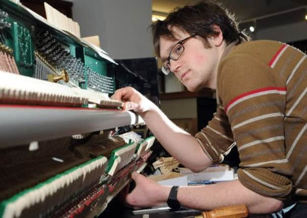 Piano technician Joe Ellis fixing the hammers into place in a Cavandish Classic Piano