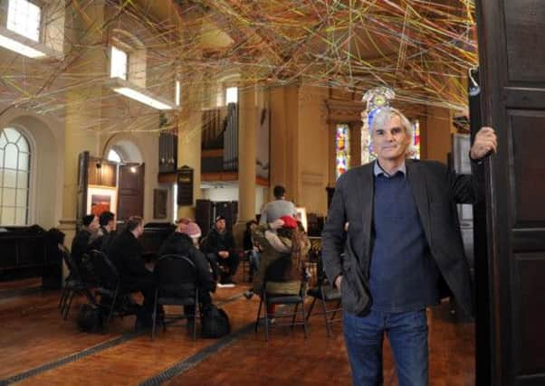 John Dawson, Director of Arts of Trinity, within the church, whilst the Trinity Theatre Group rehearsal in the newly cleared central area where the pews used to be.