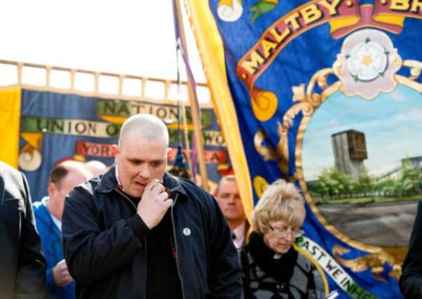 Nick Harris, former NUM branch secretary sheds a tear as a lump of coal was buried at the grave of the unknown miner at Grange Lane cemetery.