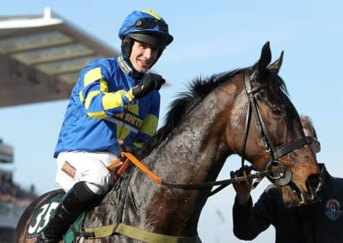 Ryan Mania celebrates on Auroras Encore after winning the John Smith's Grand National Chase during Grand National Day at the 2013 John Smith's Grand National Meeting at Aintree Racecourse, Sefton.