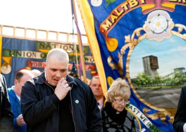 Nick Harris, former NUM branch secretary sheds a tear as a lump of coal was buried at the grave of the unknown miner at Grange Lane cemetery