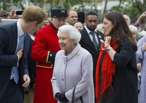 Prince Harry gives the Queen a tour of the B&Q Sentebale Forget-Me-Not Garden at the Chelsea Flower Show in London