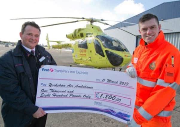 Cheque presentation from train driver David Graham to YAA paramedic Matt Syratt.