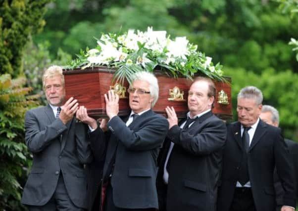 Grumbleweeds Maurice Lee and Robin Colvill carry the coffin into church, with Billy Pearce in the background.