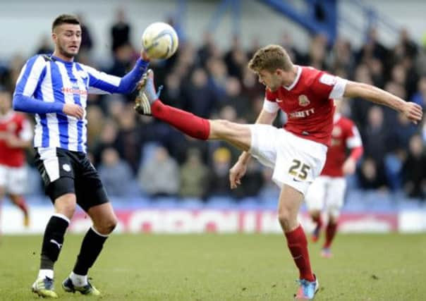 Gary Madine avoids the boot of Martin Cranie