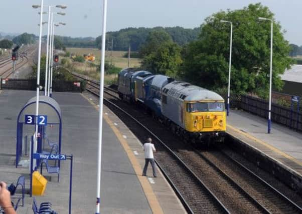 The Mallard locomotive makes its way through Church Fenton Station from the National Railway Museum, York