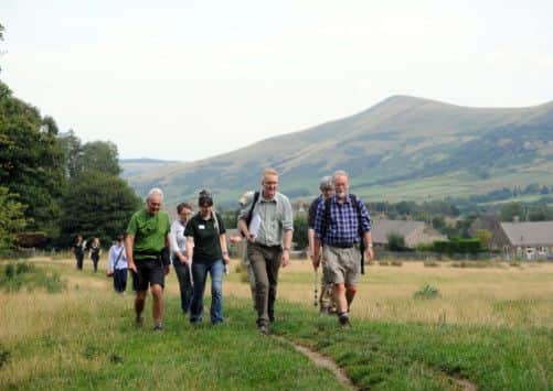 Benedict Southworth, centre, talks to walkers