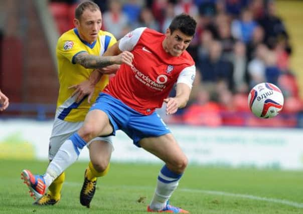 Yorks City's Michael Coulson challenges for the ball with Wimbledon's Barry Fuller.