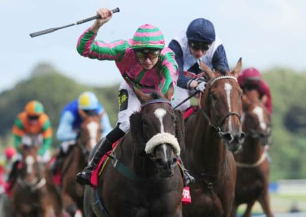 Russ Kennemore celebrates as he rides Platinum to victory