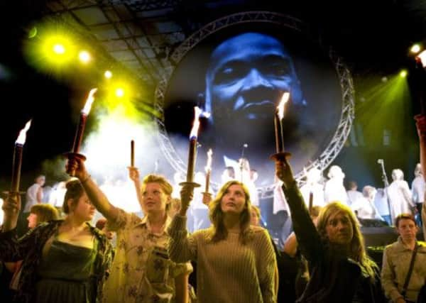 Torchbearers stand in front of an image of Martin Luther King  at the opening of Hull's Freedom Festival