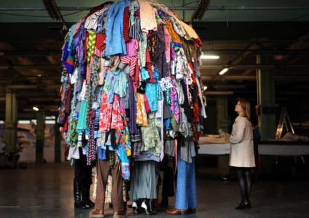 A woman views Guerra De La Paz's 'Nine' 2007 during the Christie's Big Thinking press preview at the Sorting Office, London.