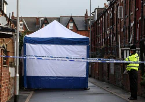 Police at the scene in Back Hill Top Avenue in the Harehills area of Leeds