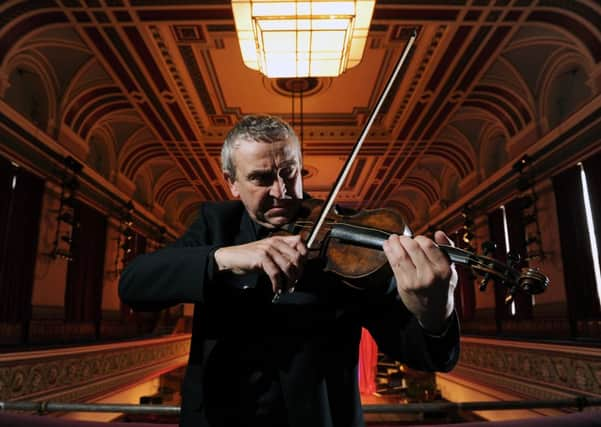 Principal violinist from Opera North David Greed tries out the instrument.  Picture by Bruce Rollinson