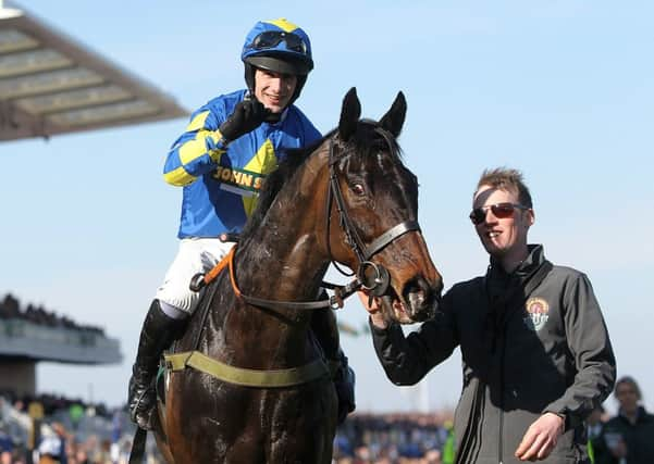 Ryan Mania celebrating on Auroras Encore after winning the John Smith's Grand National